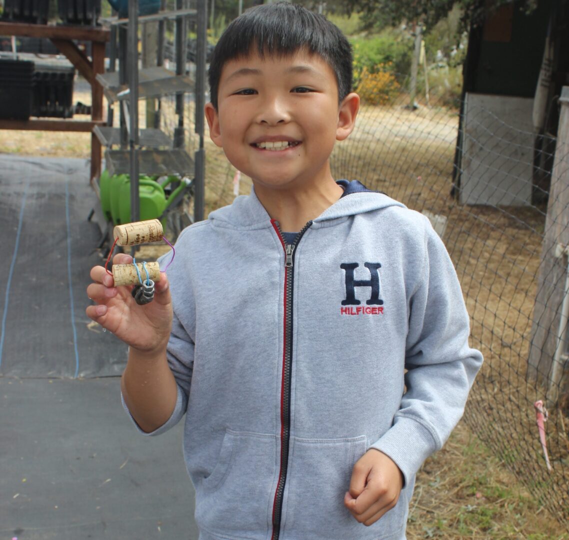 A boy holding something in his hand.