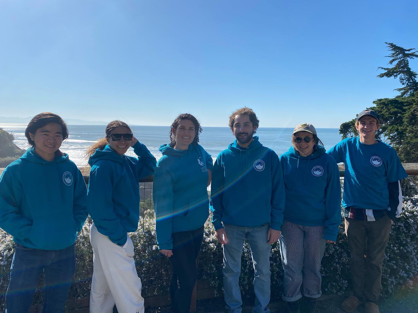 A group of people standing on top of a beach.